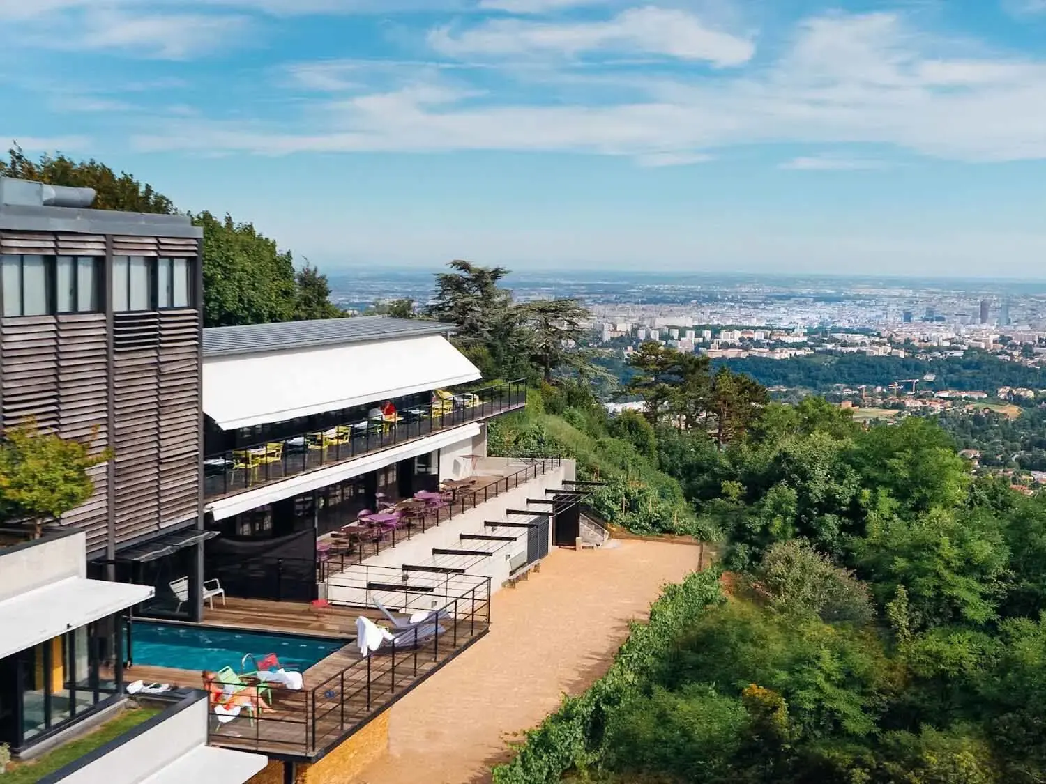 L'Ermitage on the hillside, its terrace and pool facing the view over Lyon