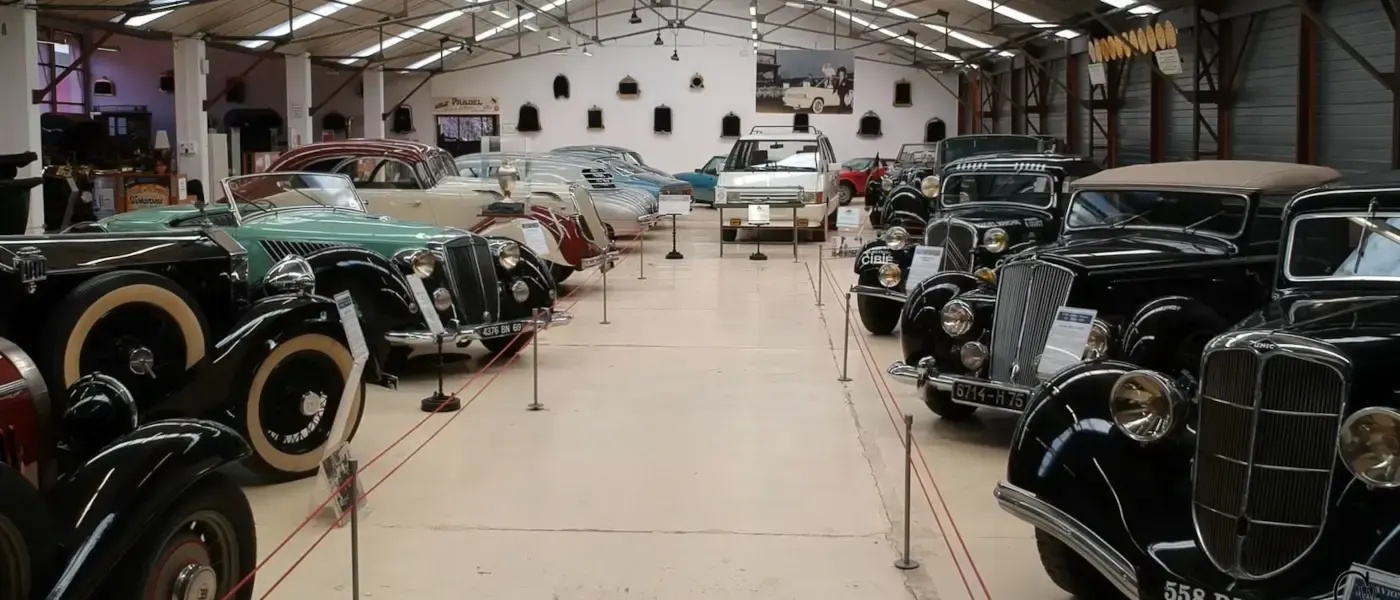 Vintage cars on display in the hall of the Henri Malartre car museum